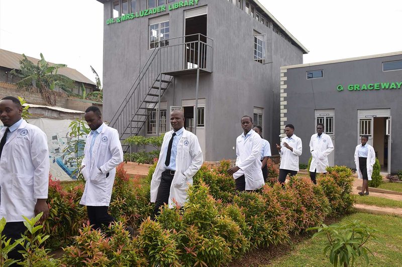 Students in white coats on the institute grounds